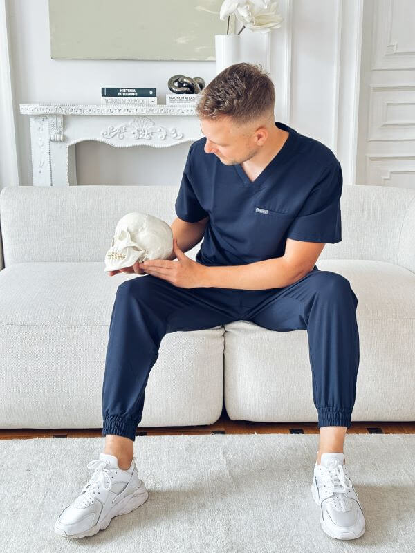 Michał Siewert performing physiotherapy technique on a skull.